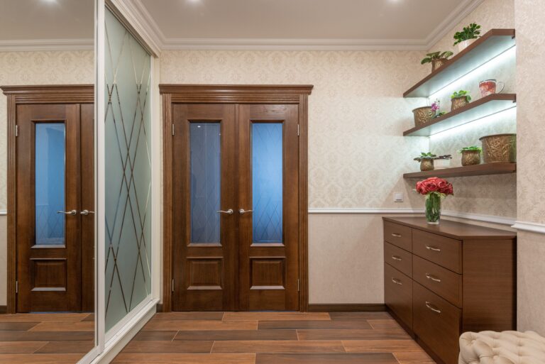 Dark wood floating shelves and entryway cabinet providing the best storage solutions for small spaces.