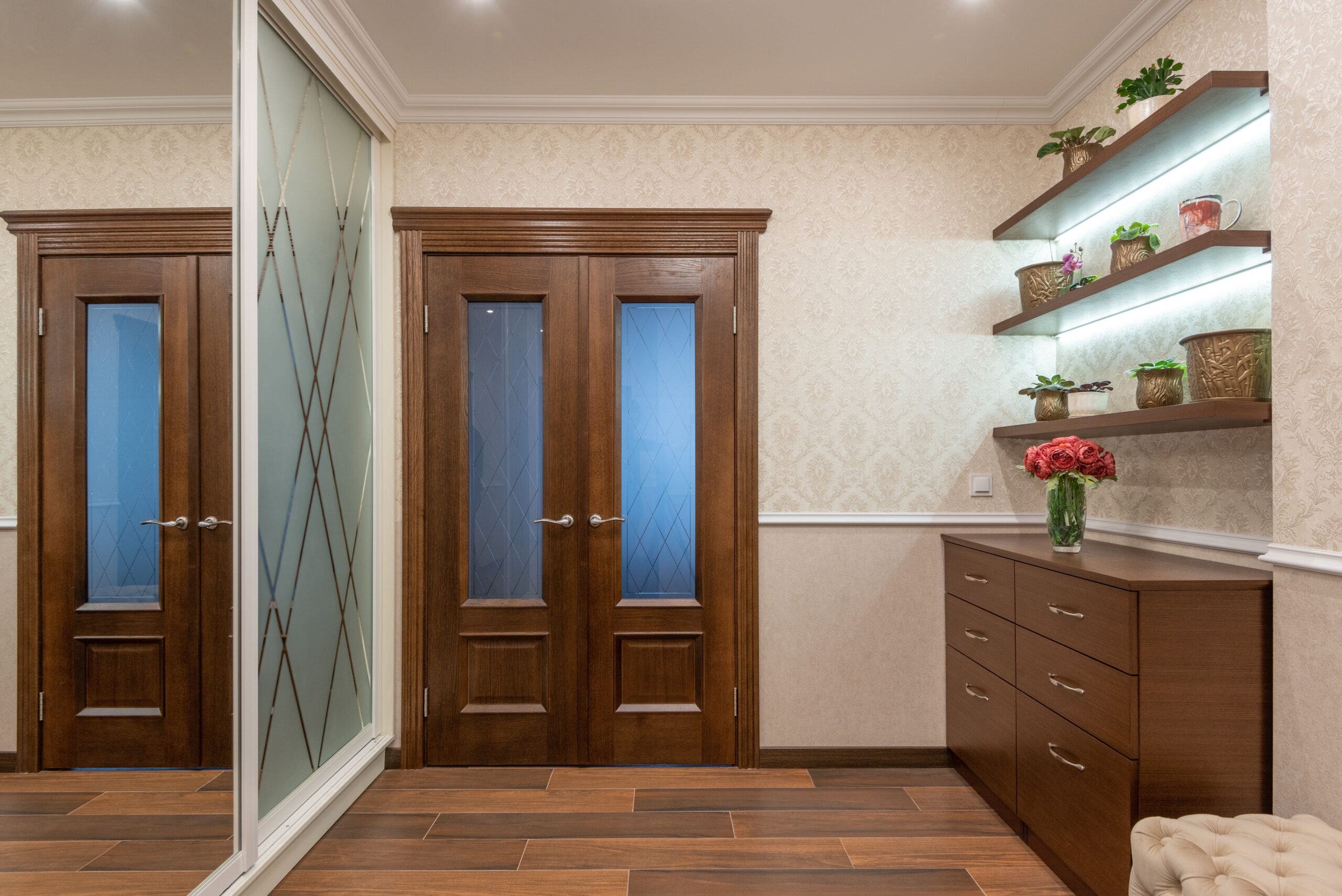 Dark wood floating shelves and entryway cabinet providing the best storage solutions for small spaces.
