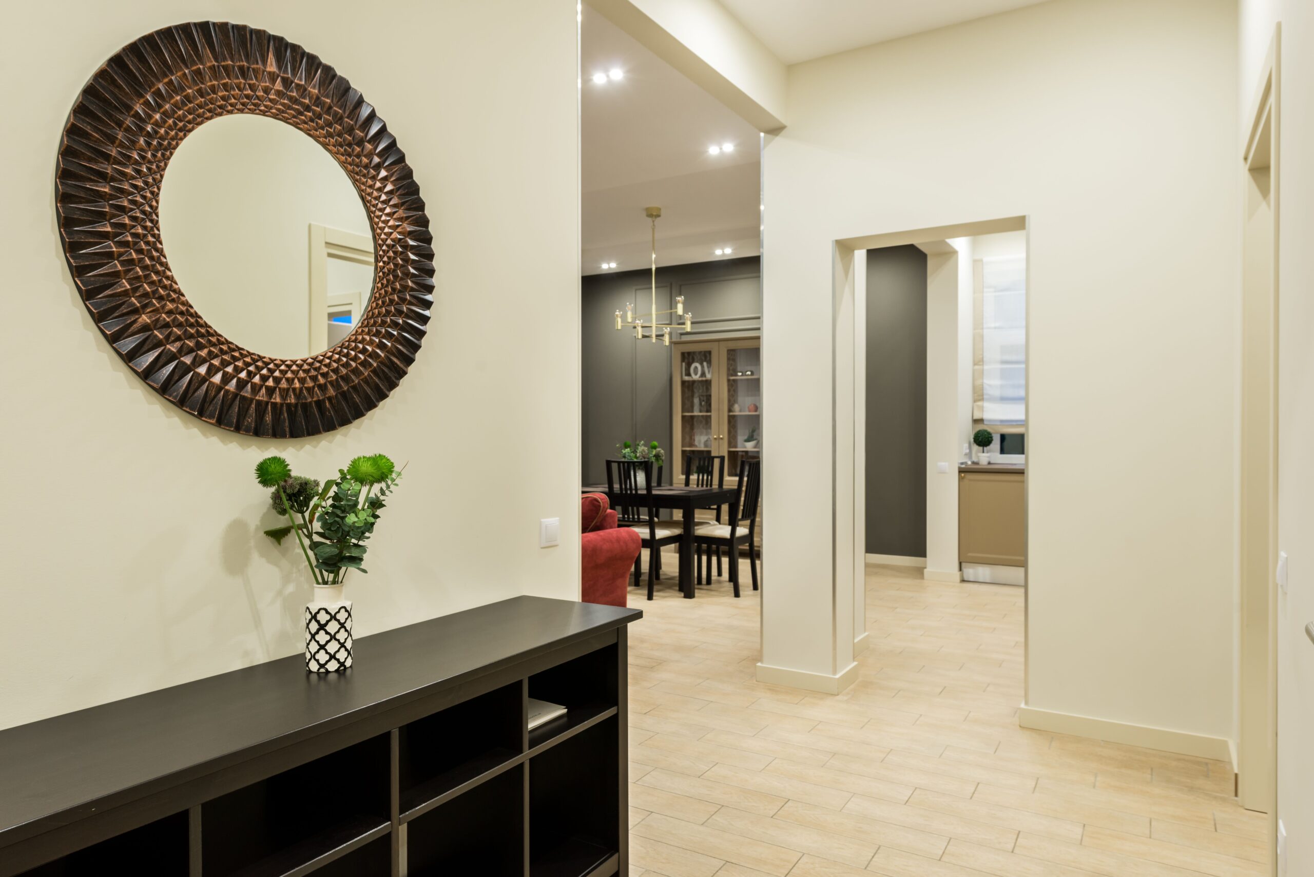 Entryway decor with mirror placed on a perpendicular wall in a feng shui small living room layout