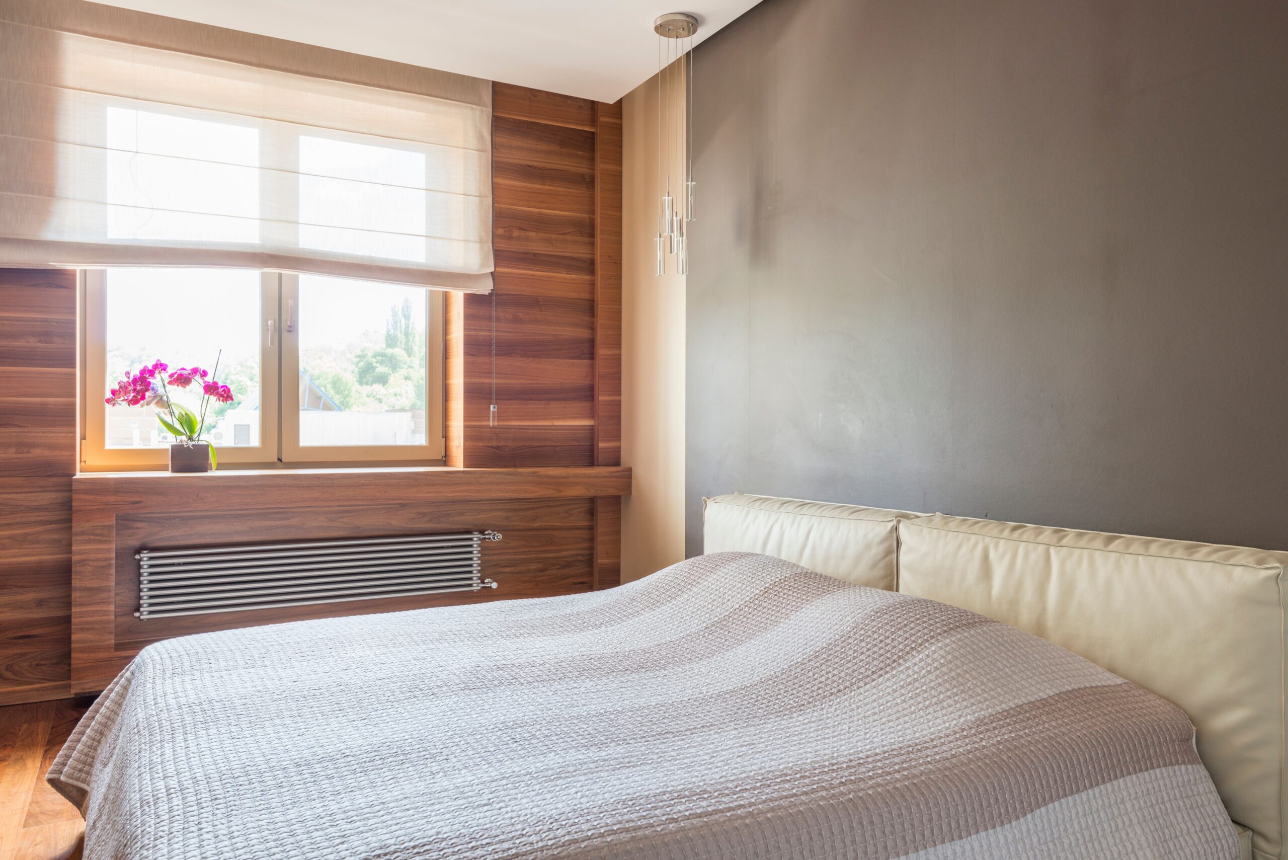 Space saving Murphy wall bed in a stylish small apartment bedroom